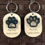 My Kids Have Paws and My Kids Have Claws maple keychains with black acrylic paw print and claw on dark background