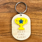 Best Dad Ever laser-cut maple wood keychain with yellow acrylic trophy and blue star detail
