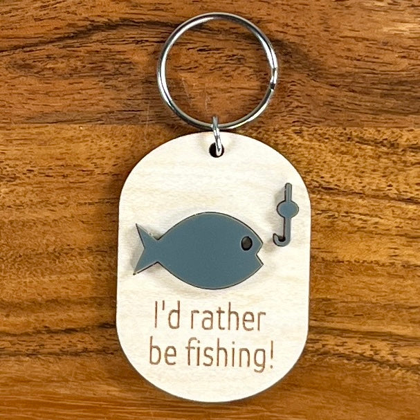 I'd Rather Be Fishing laser-engraved maple wood keychain with blue acrylic fish and hook on wood background
