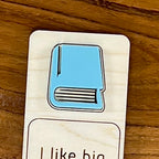 Close-up of laser-engraved detail on eucalyptus acrylic book of I Like Big Books birch bookmark