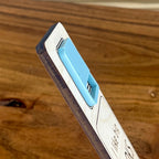 Side view of I Like Big Books and I Cannot Lie birch bookmark showing dimensional acrylic layers