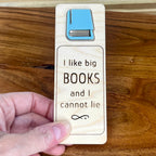 Hand holding I Like Big Books and I Cannot Lie birch bookmark showing eucalyptus acrylic book detail