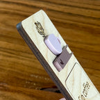 Side view of Sip Coffee Read Books Stay Cozy birch bookmark showing dimensional acrylic layers