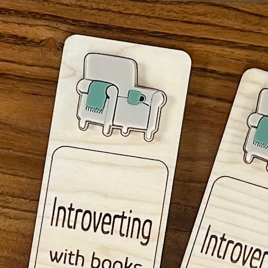 Close-up of sage acrylic cozy chair and mug on Introverting with Books birch bookmark