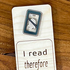Close-up of charcoal acrylic phone with muted bell icon on I Read Therefore I Ignore People birch bookmark