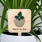 Mint to Be maple wood plant stake with dark green acrylic mint leaves in a white pot