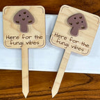 Two Here for the Fungi Vibes maple wood plant stakes with mauve acrylic mushroom accent side by side