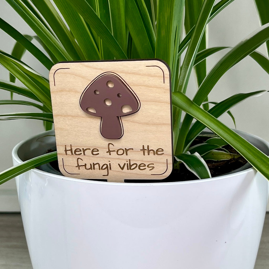 Here for the Fungi Vibes maple wood plant stake with mauve acrylic mushroom in a white pot
