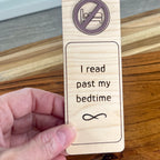 Hand holding I Read Past My Bedtime birch bookmark showing mauve acrylic detail