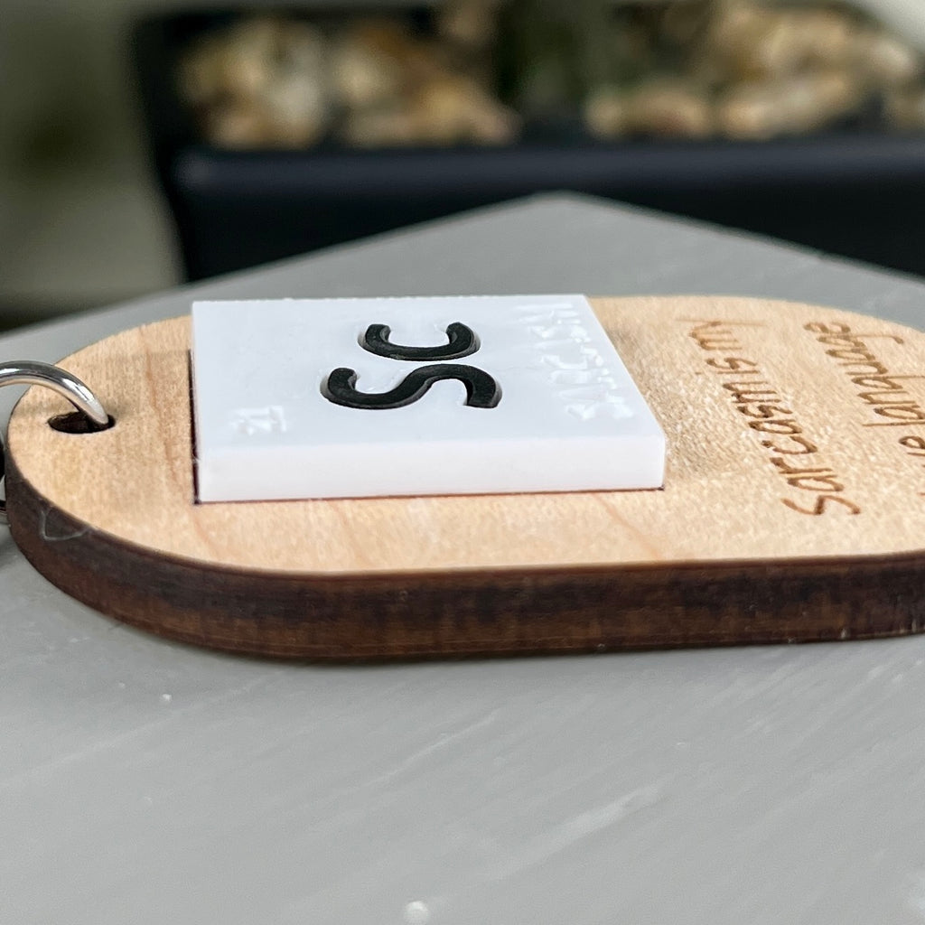 Sc Sarcasm Is My Love Language laser-engraved wood keychain flat lay on neutral background