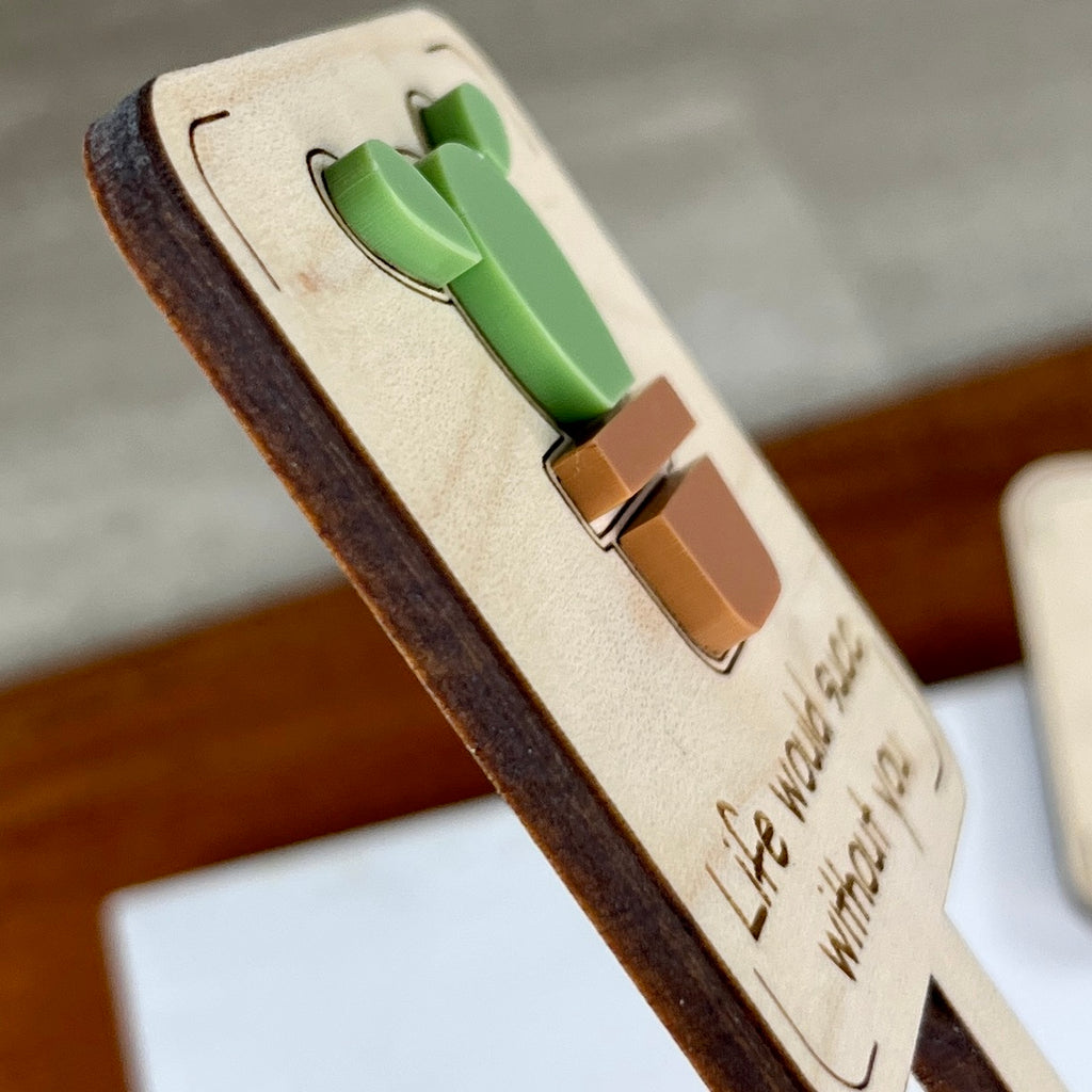 Side view of Life Would Succ Without You plant stake showing layered maple wood and green acrylic depth