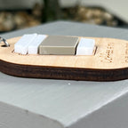 A side view close-up of a wooden laser-engraved keychain featuring an acrylic coffee cup to highlight the 3D nature of the design.