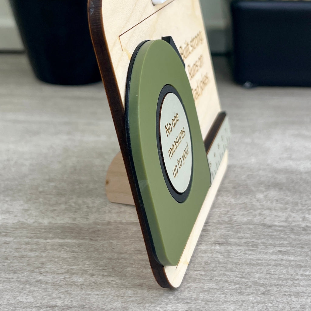 Angled view of personalized maple and acrylic tape measure magnet with layered detail