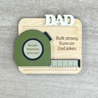 Flat lay of handcrafted tape measure fridge magnet made from natural maple with matte acrylic