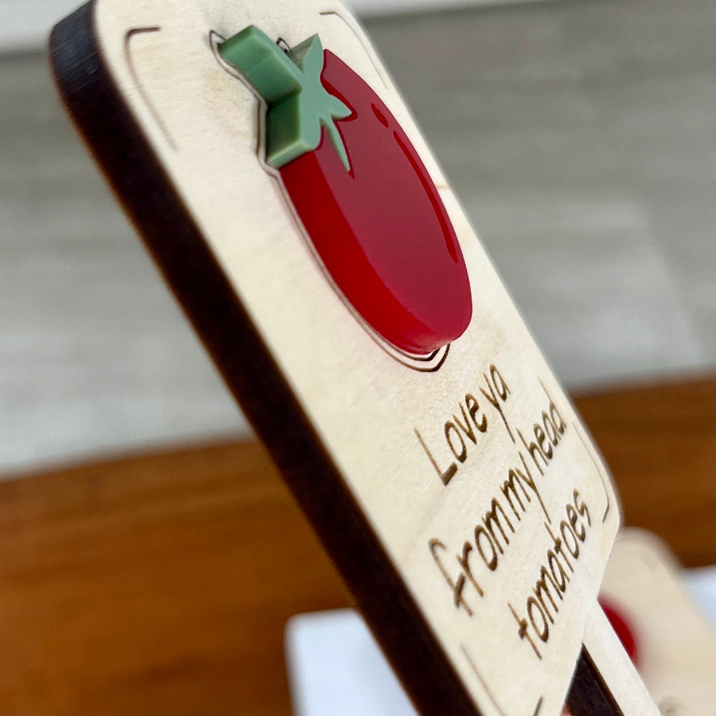 Side view of Love Ya From My Head Tomatoes plant stake showing layered maple wood and red acrylic depth