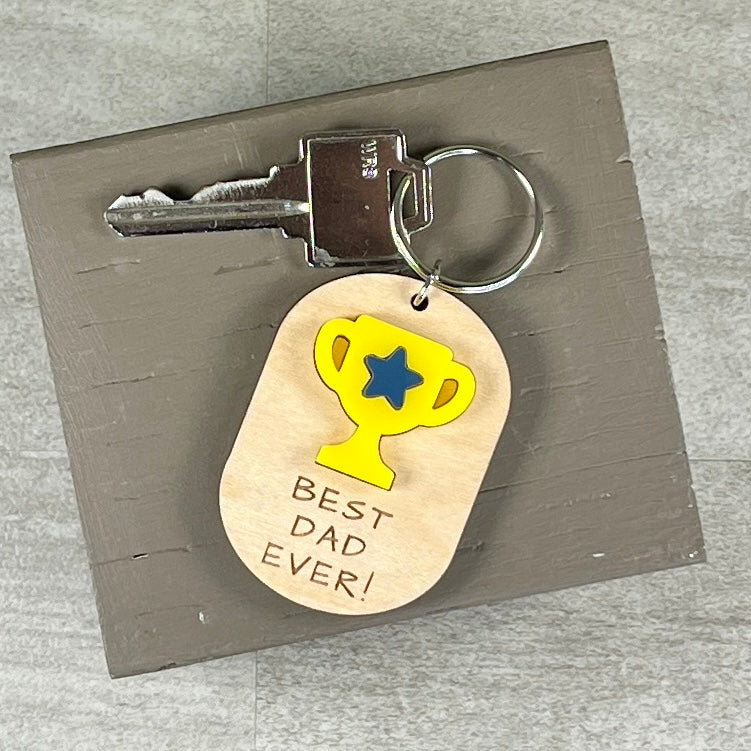 Best Dad Ever wood keychain with key ring on neutral background