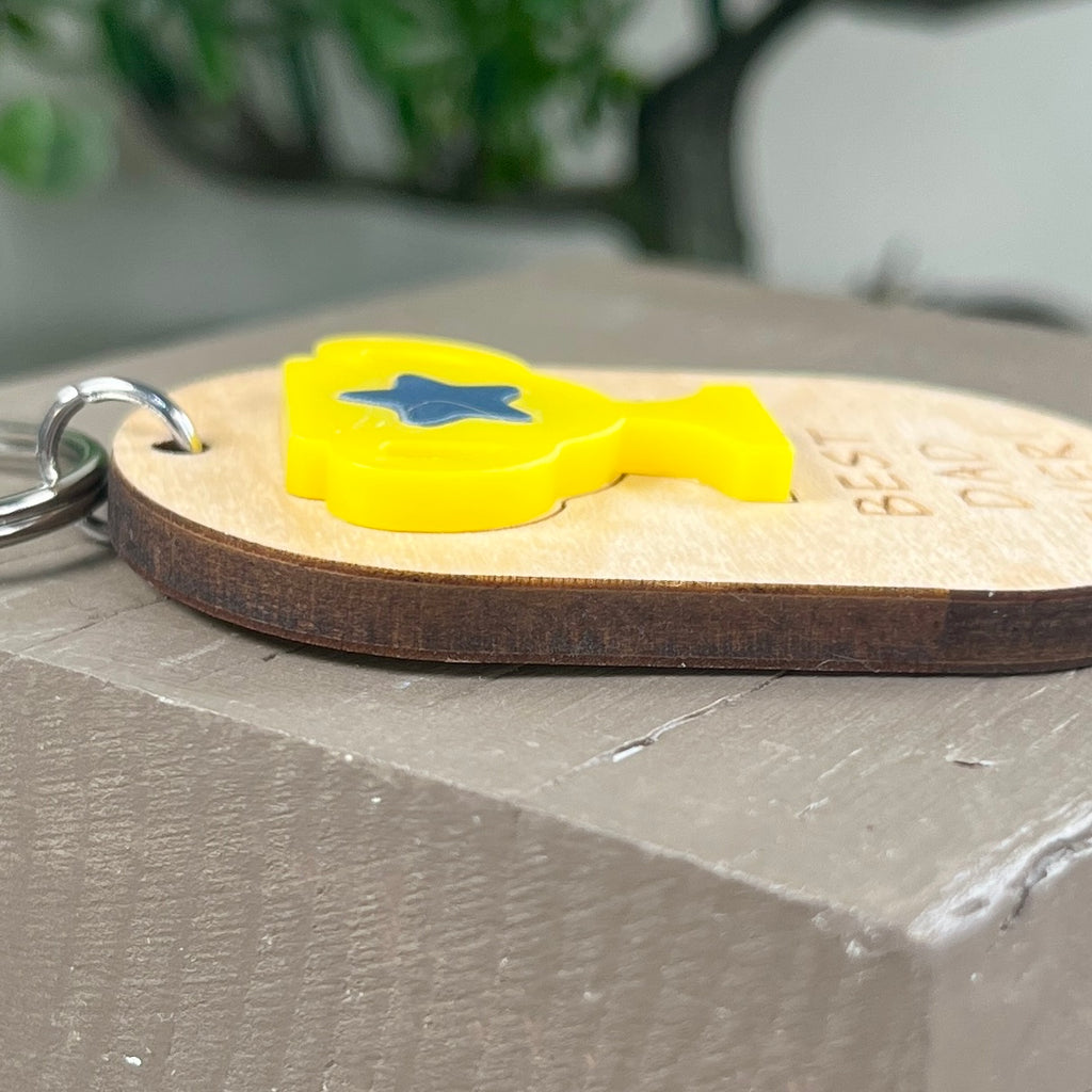 Side view of Best Dad Ever maple keychain with yellow acrylic trophy accent