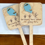 Two Growing Thru What I'm Going Thru maple wood plant stakes with blue watering can acrylic accent