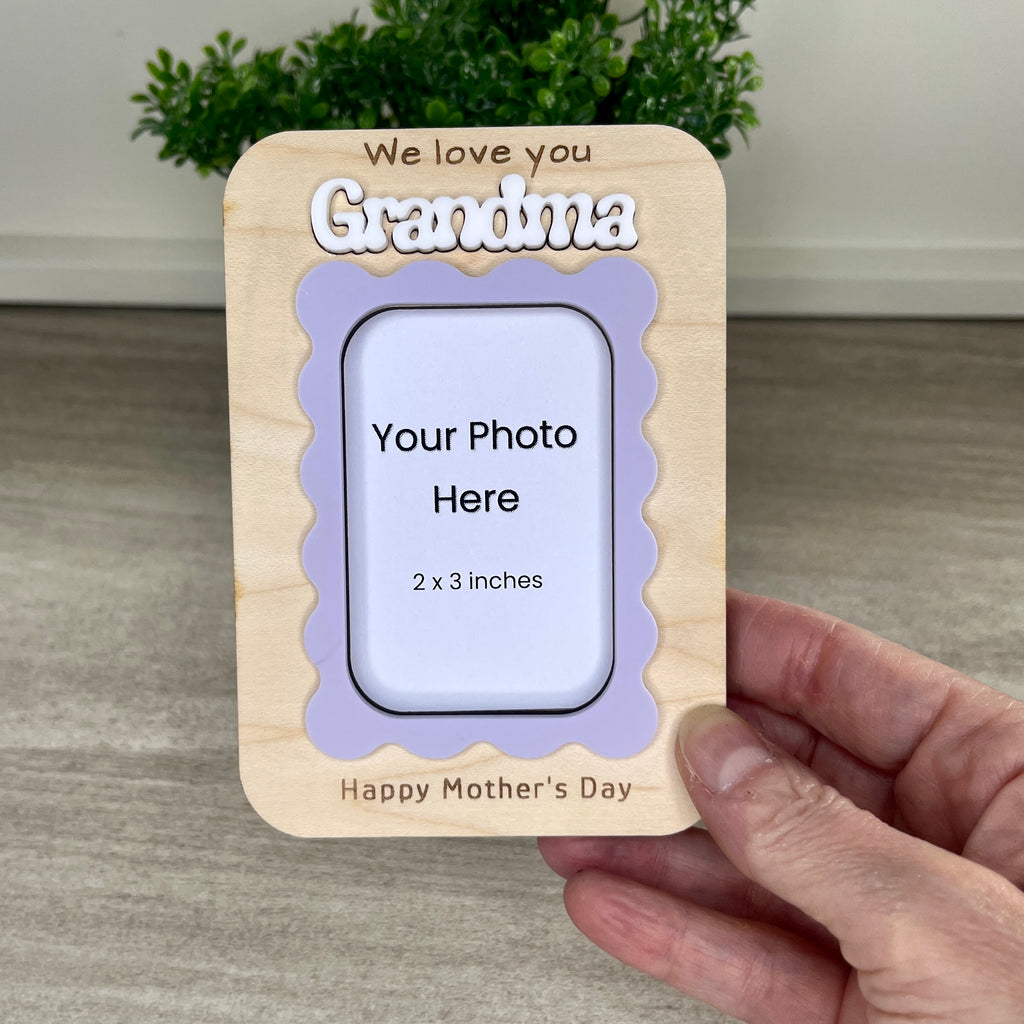 Handcrafted wavy frame magnet held in hand showing personalized name and I Love You engraved message