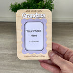 Handcrafted wavy frame magnet held in hand showing personalized name and I Love You engraved message