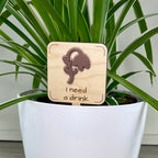 I Need a Drink maple wood plant stake with mauve acrylic wilted flower in a white pot